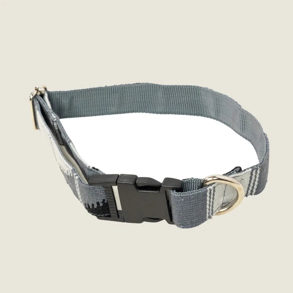 Adjustable Boho dog collar in black and gray cotton with a secure plastic buckle and metal D-ring for leash attachment.