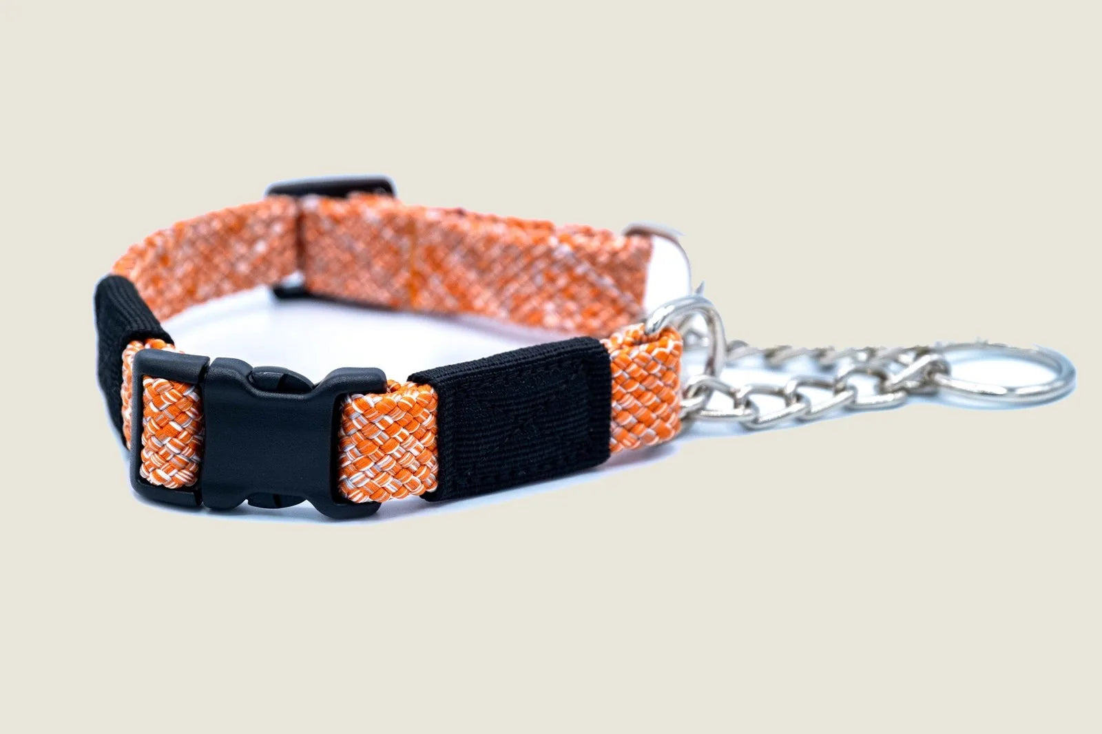 Orange flat weave climbing rope martingale collar with a strong black buckle and a silver chain attachment.