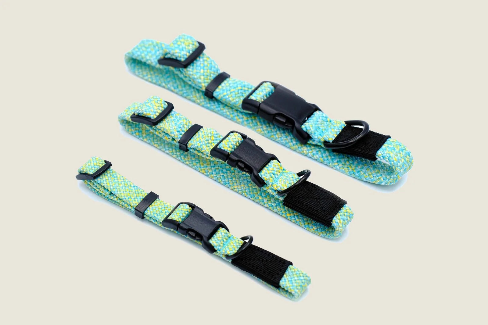 Brightly colored nylon climbing rope dog collars in green and yellow, featuring strong black buckles, available in three s...