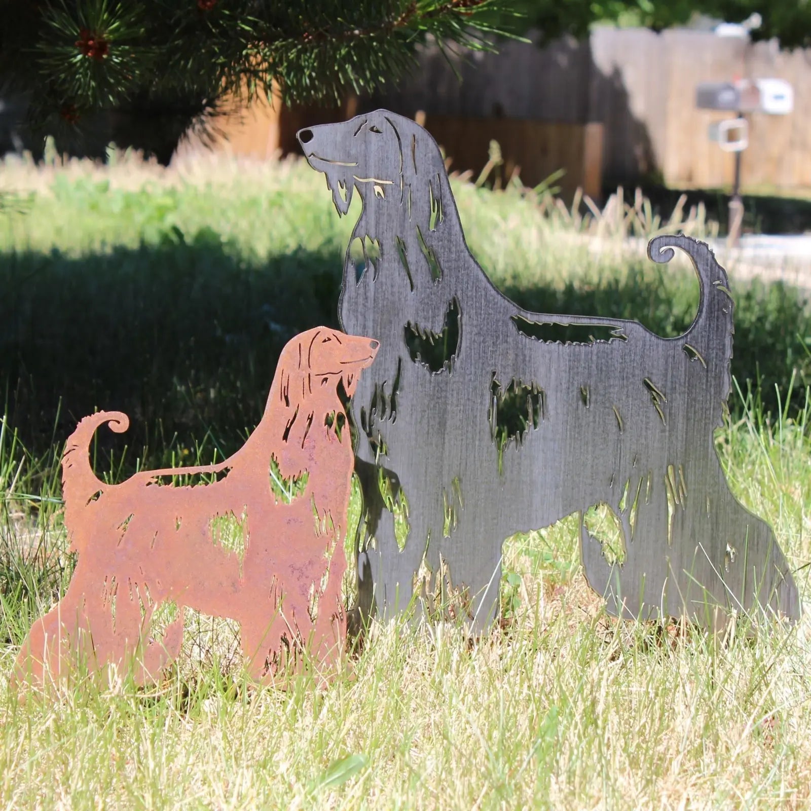 Afghan Hound metal silhouettes in Corten steel and matte black, set on grassy ground, showcasing dog-themed decor.