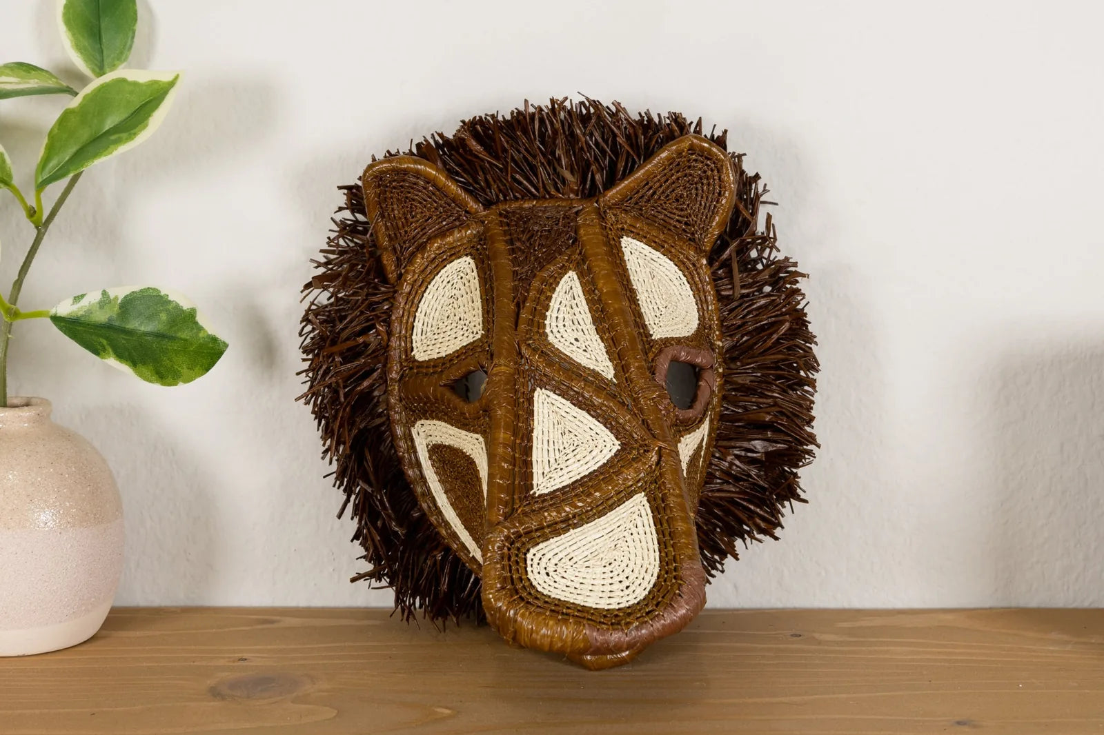 Handwoven African Wild Dog mask featuring brown and cream patterns with natural materials, enhancing your wall decor.