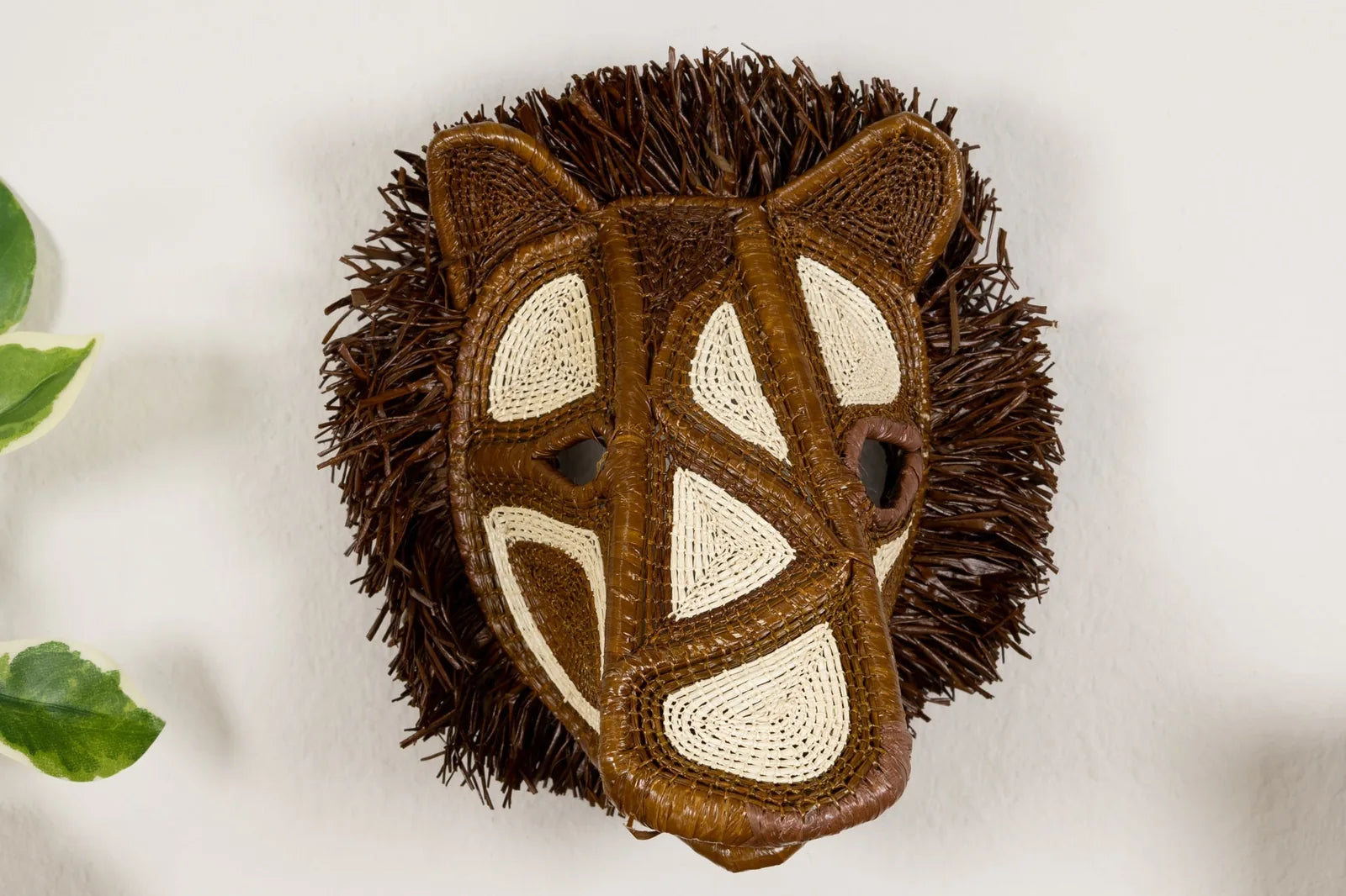 Handwoven African Wild Dog mask featuring intricate brown and cream patterns, crafted from natural materials.