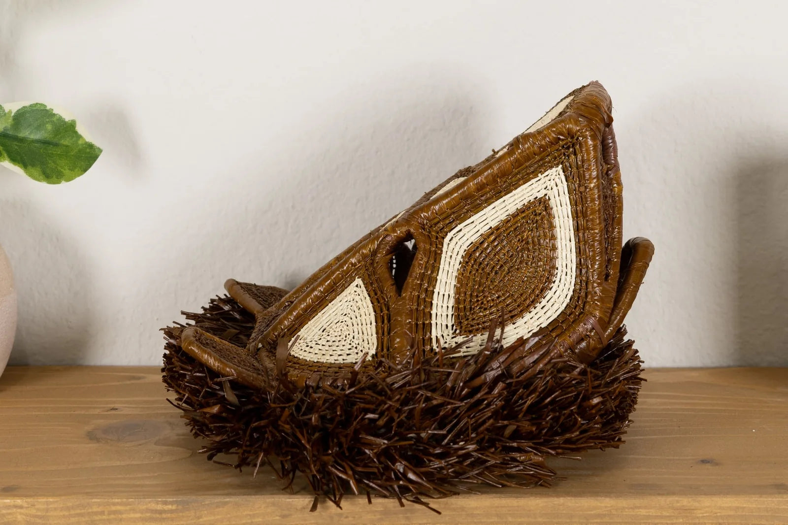Handwoven African Wild Dog mask in earthy browns and whites, featuring intricate patterns and natural fibers.