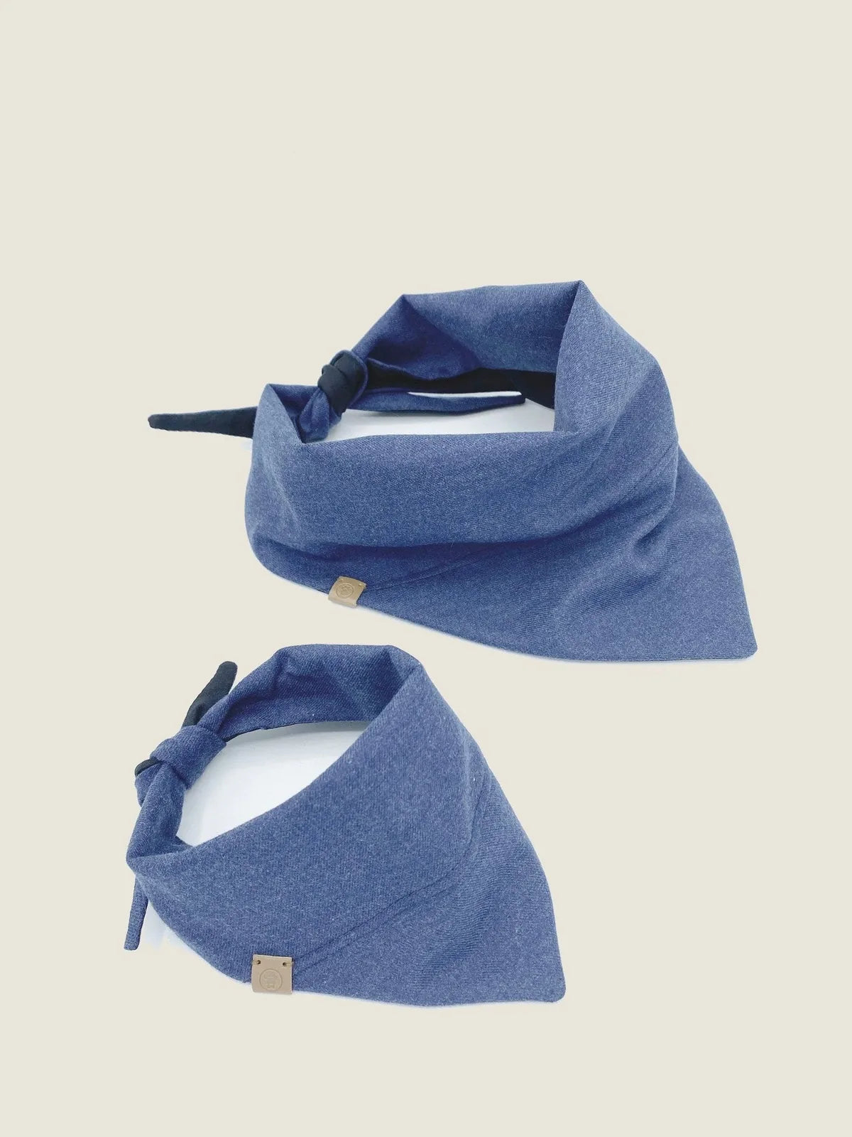 Reversible navy blue pet bandana made of soft cotton flannel with adjustable tie, featuring a stylish, casual design.