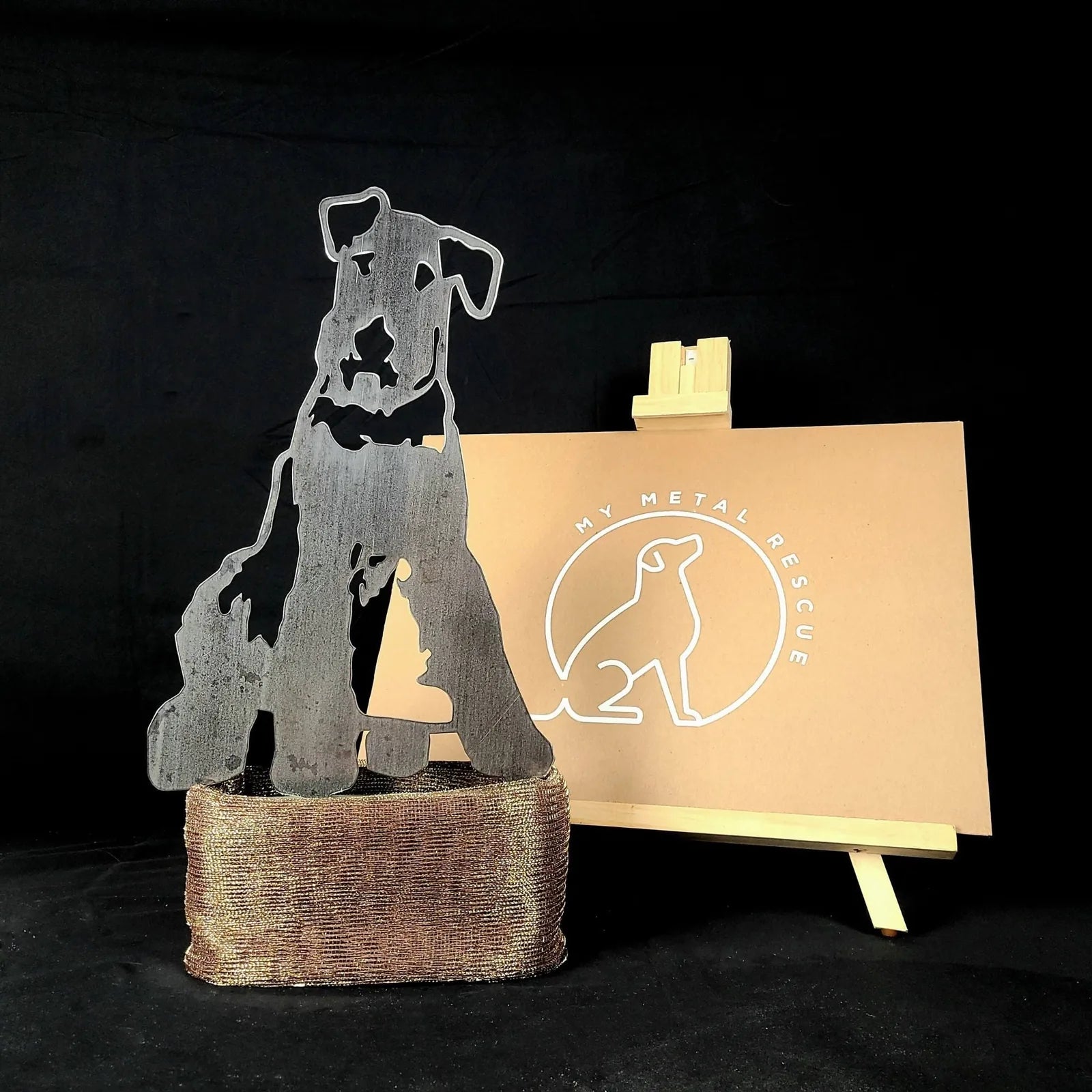Airedale Terrier metal silhouette in weathered steel, presented on a textured base with a My Metal Rescue sign in the back...