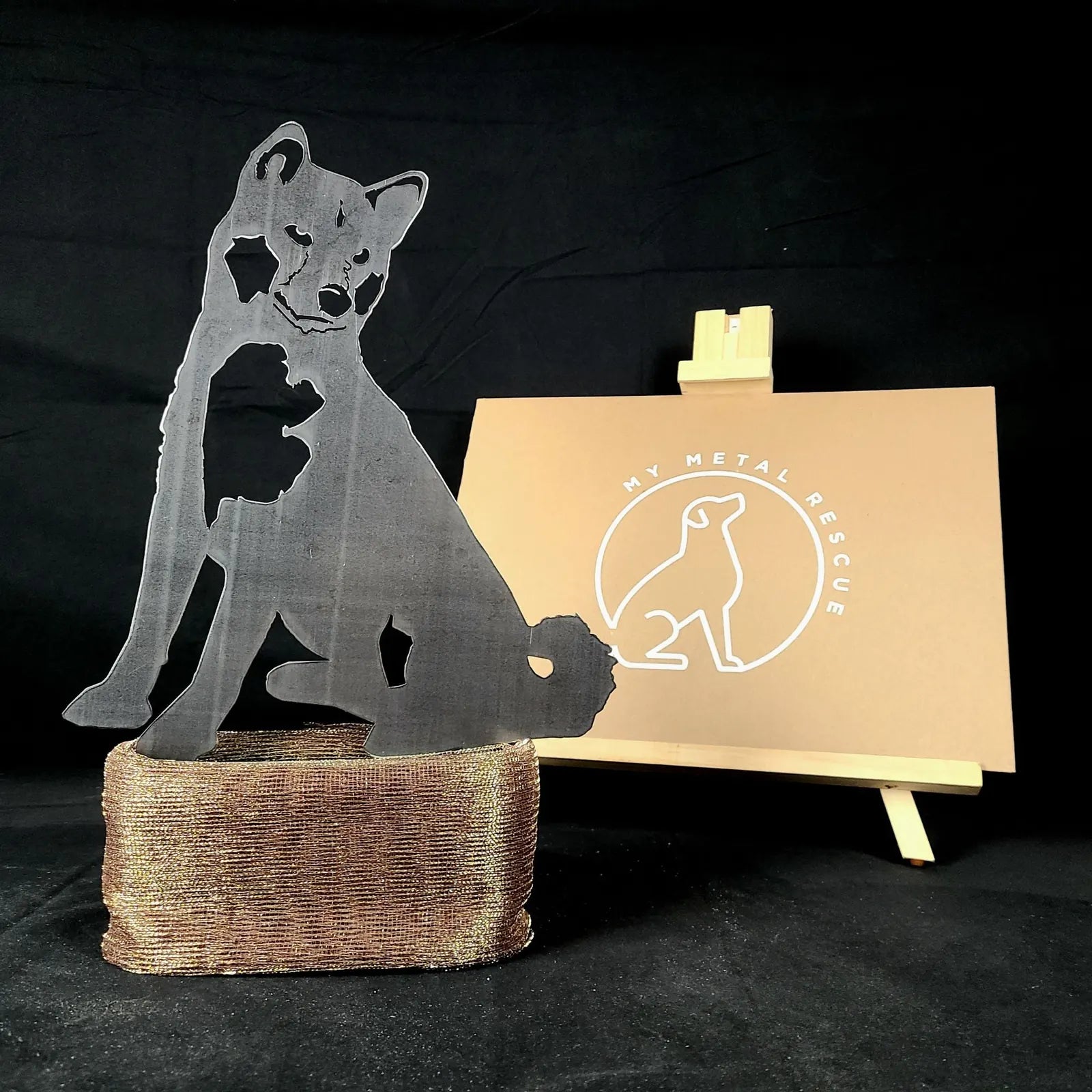Black metal Akita silhouette on a textured base, showcasing dog breed art by My Metal Rescue, set against a dark background.