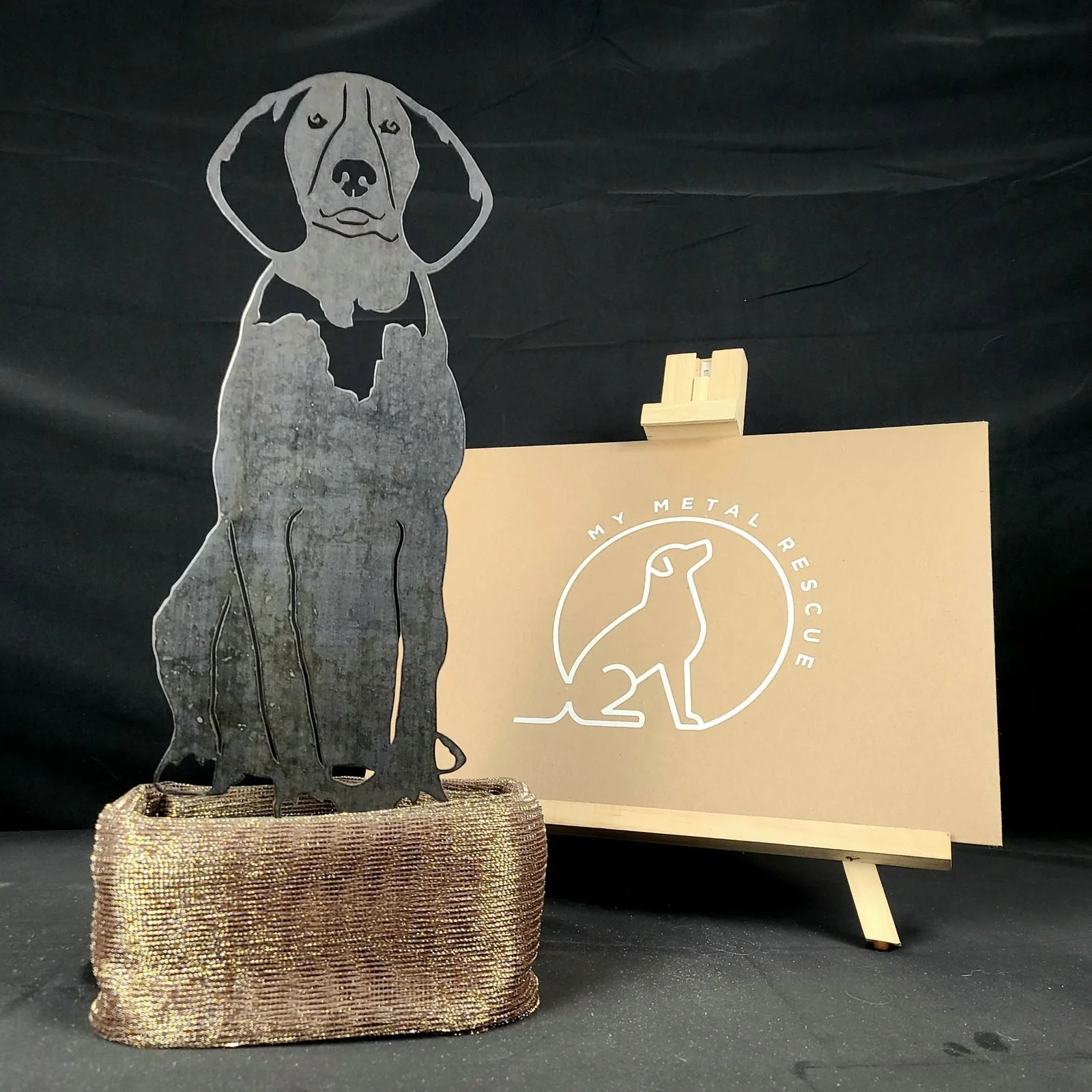 Handcrafted metal silhouette of an American English Coonhound, displayed with a rustic brown base.