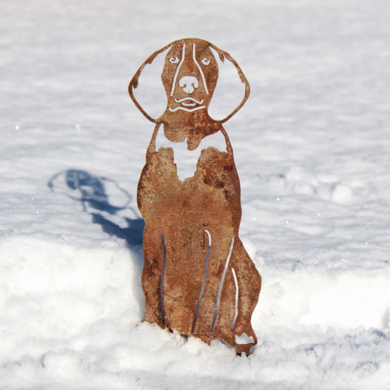 Rusty metal silhouette of an American English Coonhound standing in snow, showcasing intricate cutout details.