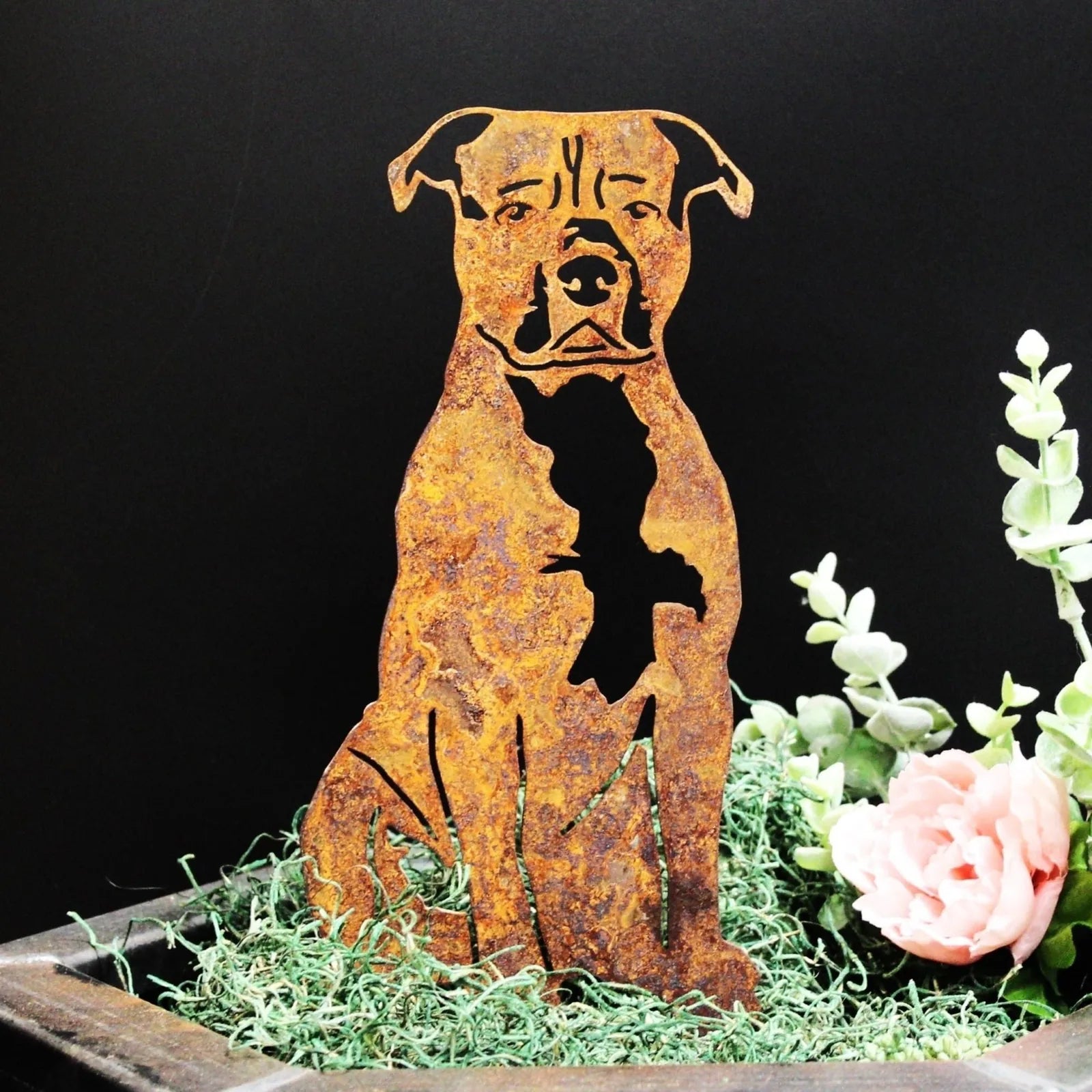 Handcrafted metal silhouette of an American Staffordshire Terrier in rusted Corten steel, set against a dark background wi...