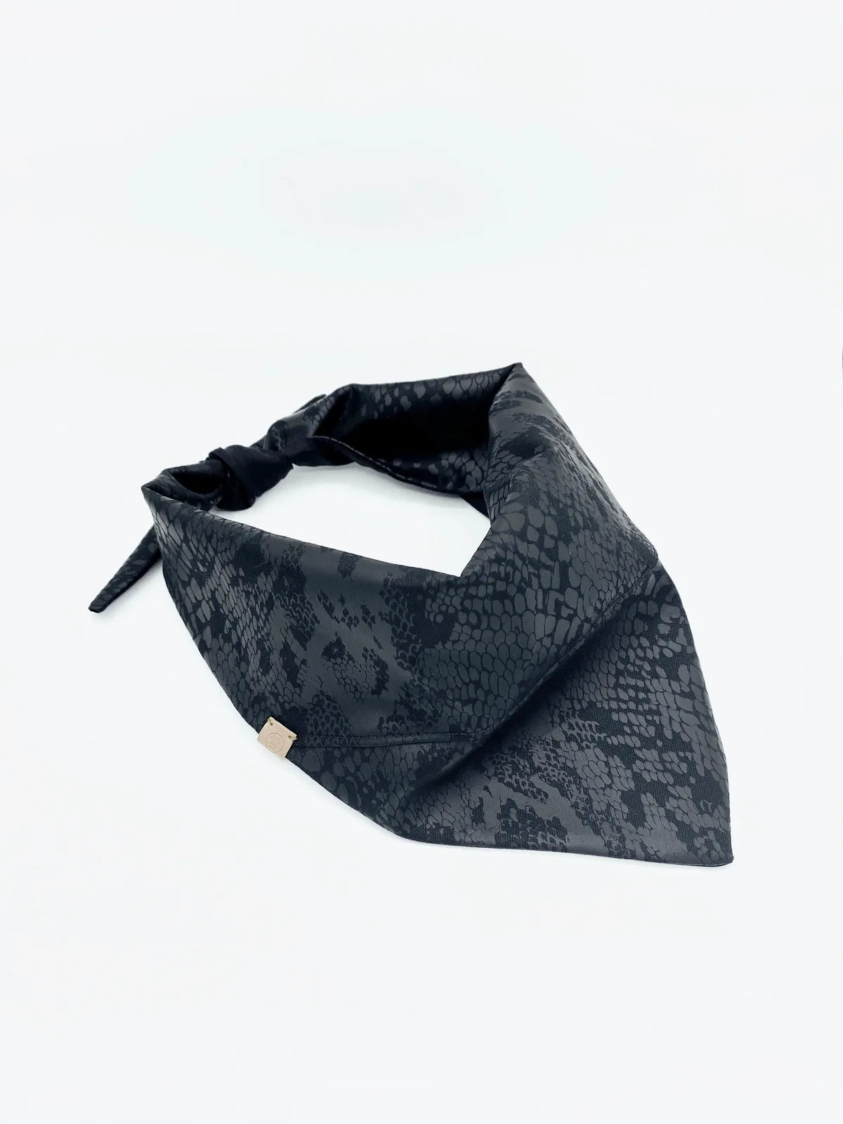 Reversible black pet bandana featuring a sleek snake print design, crafted from soft cotton for comfort and style.