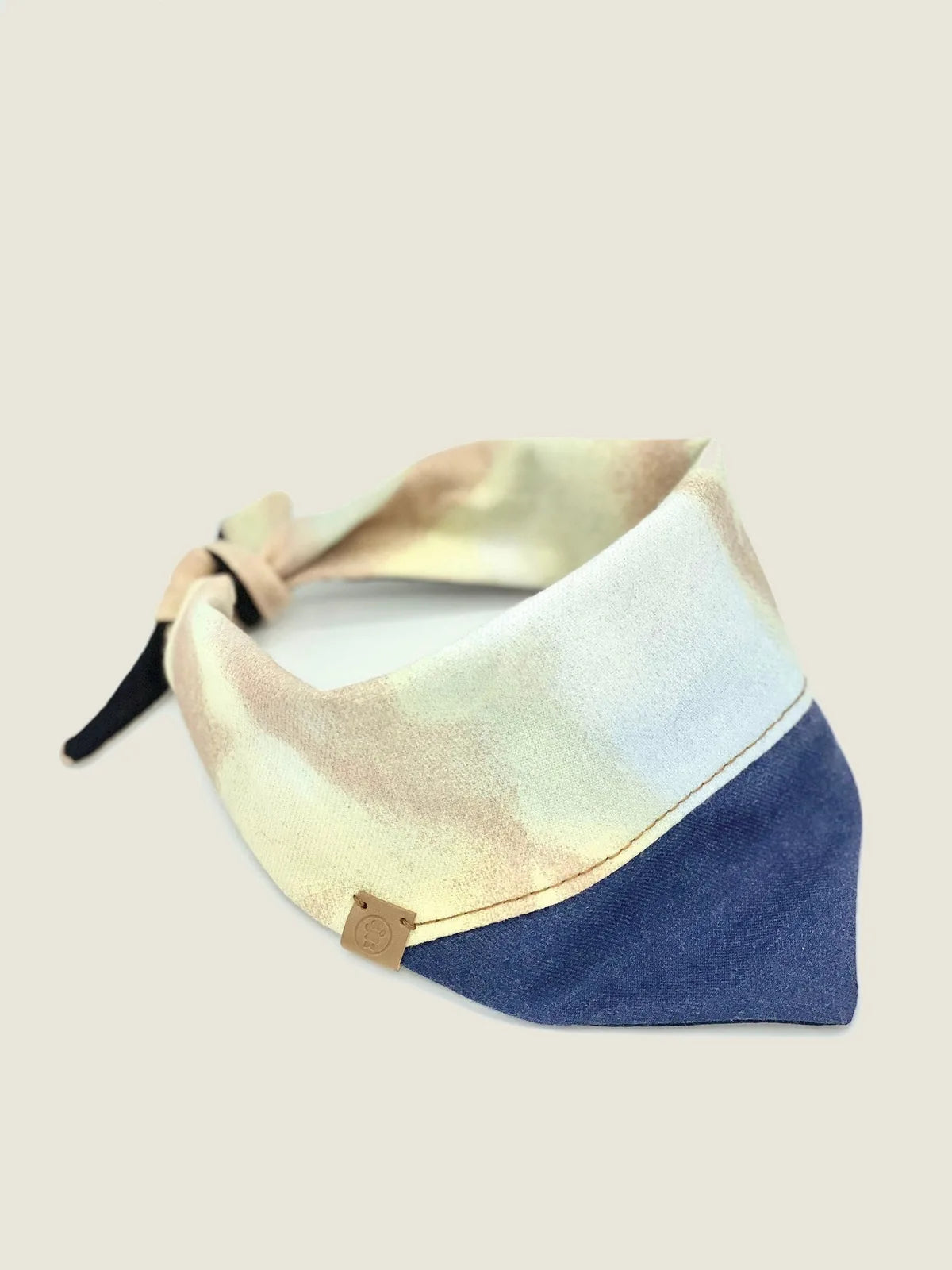 Reversible pet bandana in light pastel colors paired with a navy blue bottom, featuring soft cotton material and adjustabl...