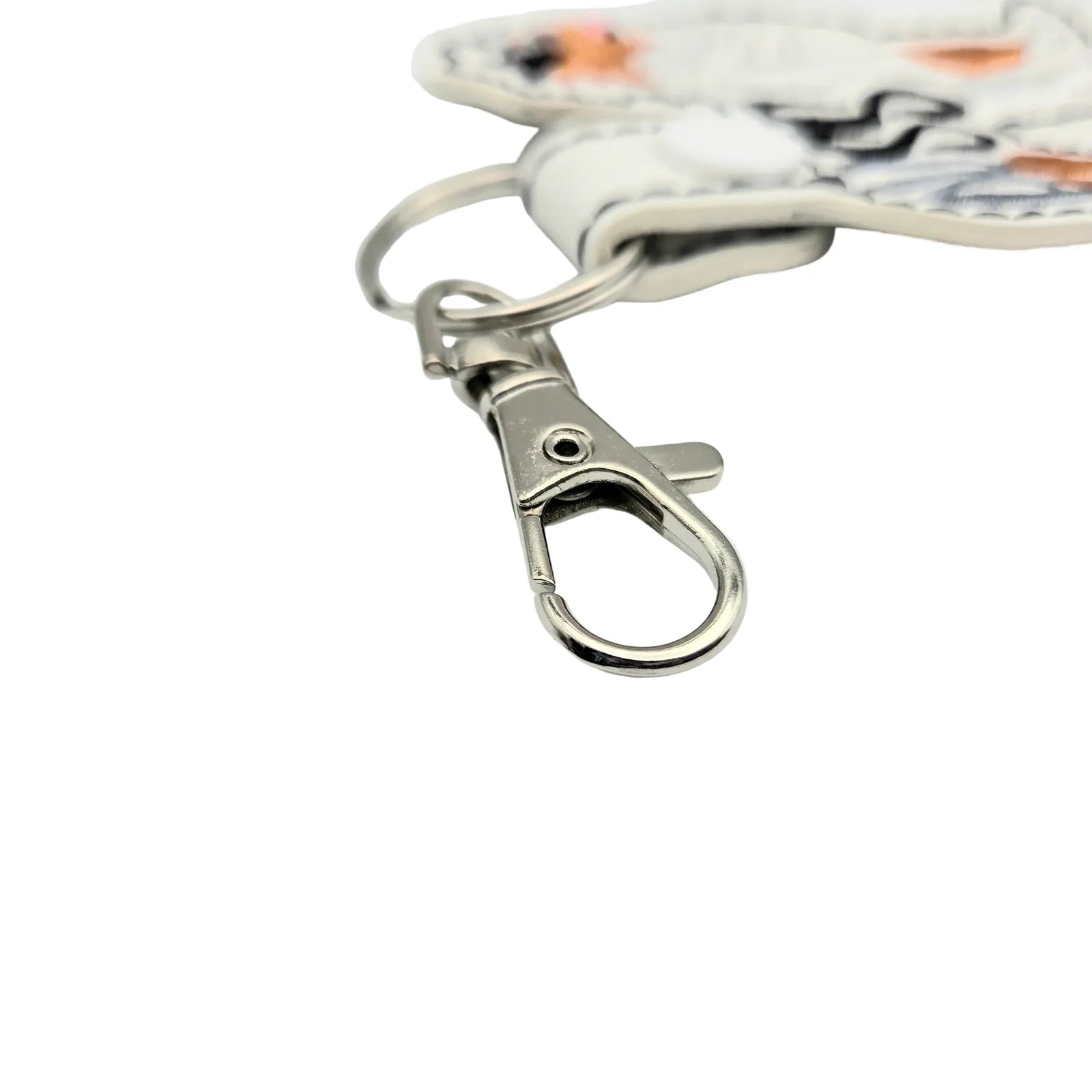 Silver metal swivel clasp attached to a white snap tab charm with an Australian Shepherd design.