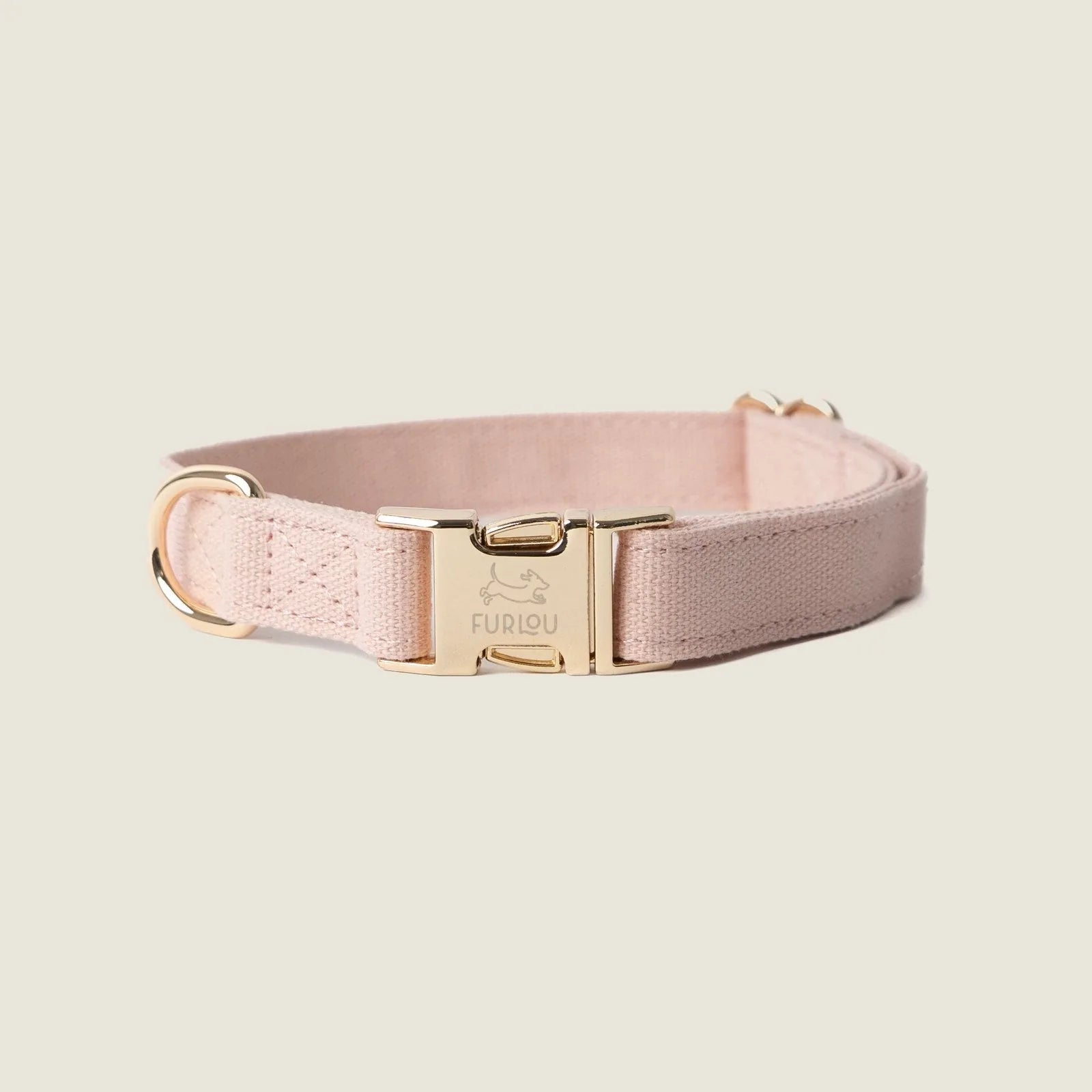 Baby pink canvas dog collar with gold hardware, featuring a lightweight design for everyday comfort.
