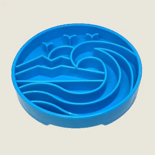 Light blue shallow dog bowl with raised ridges and wave-inspired design, promoting slower eating and mental enrichment.