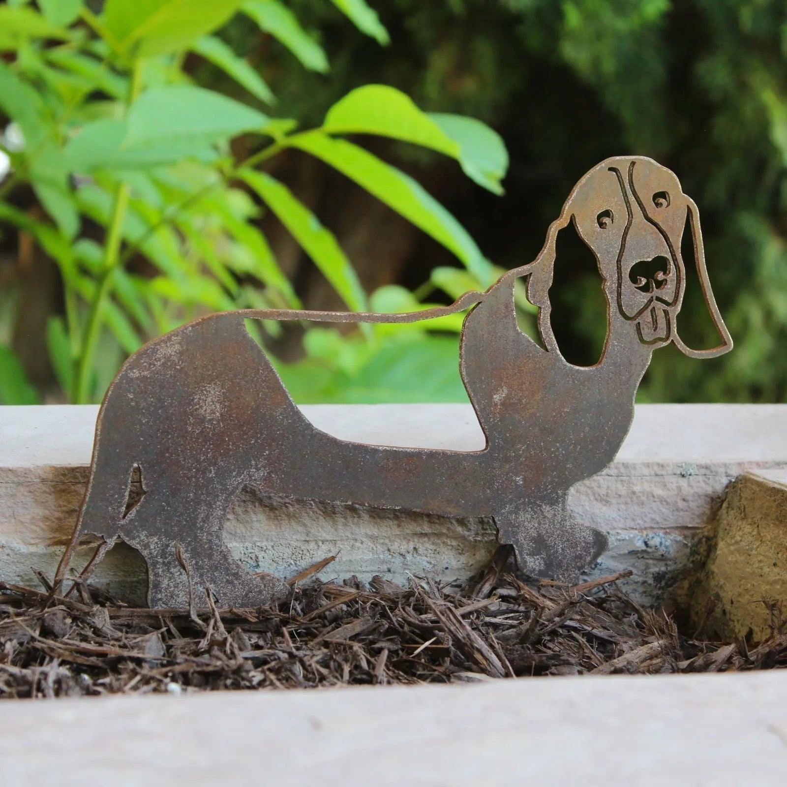 Rusty Corten steel Basset Hound silhouette garden decor, showcasing intricate detailing and playful design.