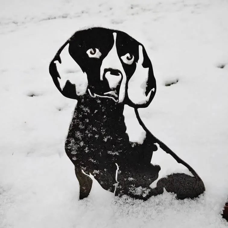 Beagle metal silhouette in black, partially covered in snow, showcasing a rustic design for outdoor decor.
