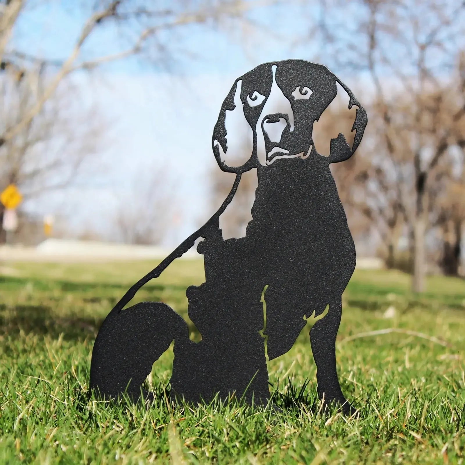 Black metal Beagle silhouette standing on grass, crafted from sturdy weathering steel, perfect for outdoor decor.