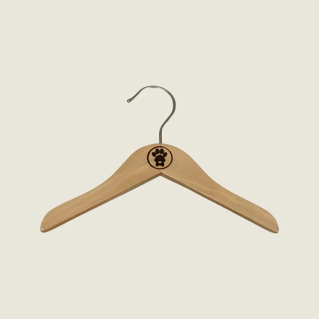 Bespoke Paws wooden hanger with a paw print logo and metal hook, perfect for organizing your dog's clothing.