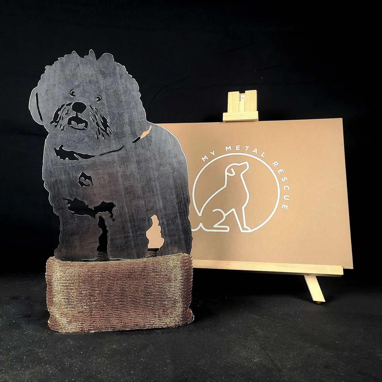Bichon Frise silhouette in weathered steel, showcased on a rustic base, with a branded background from My Metal Rescue.