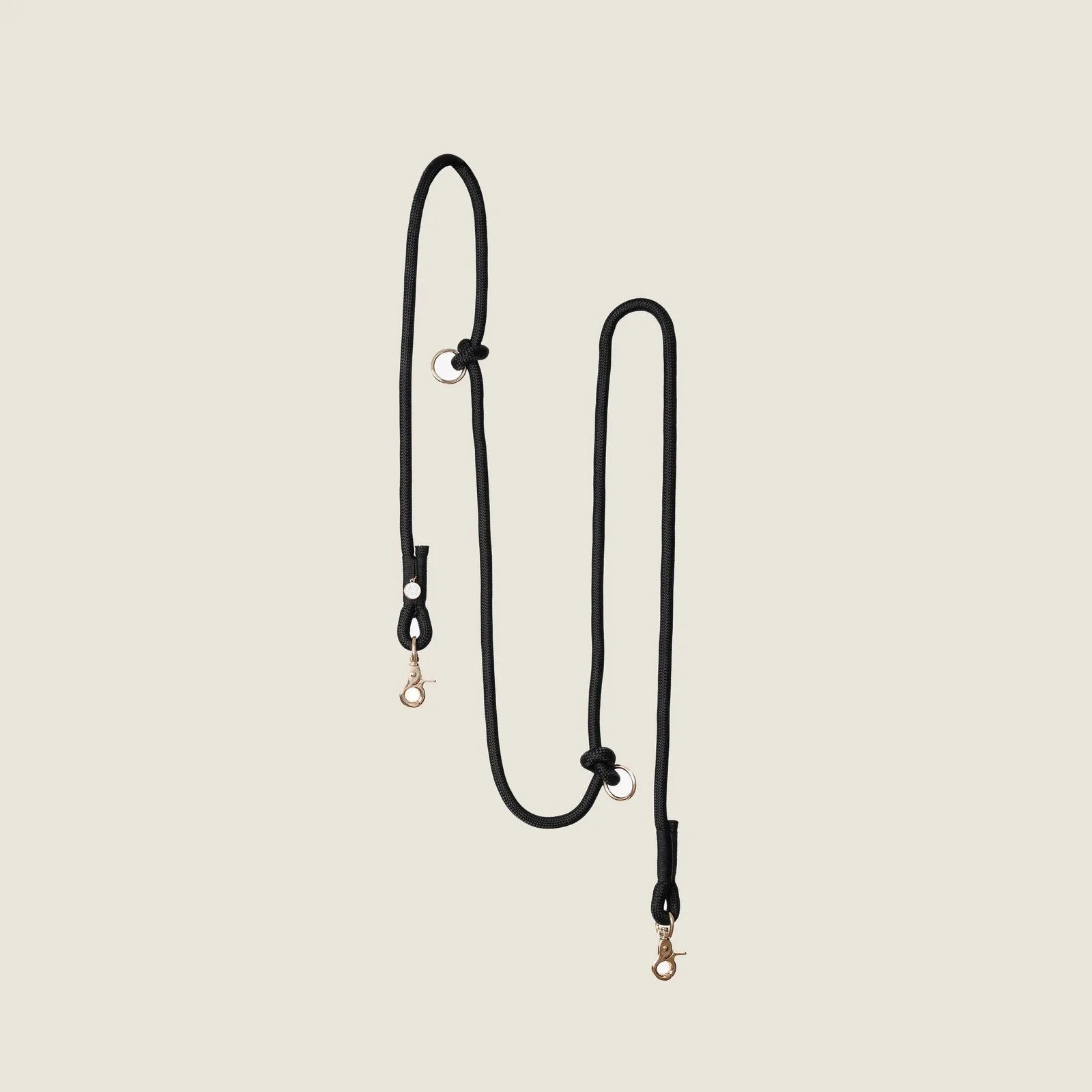 Hands-free black braided leash by FURLOU with gold clips, designed for comfortable dog walking.