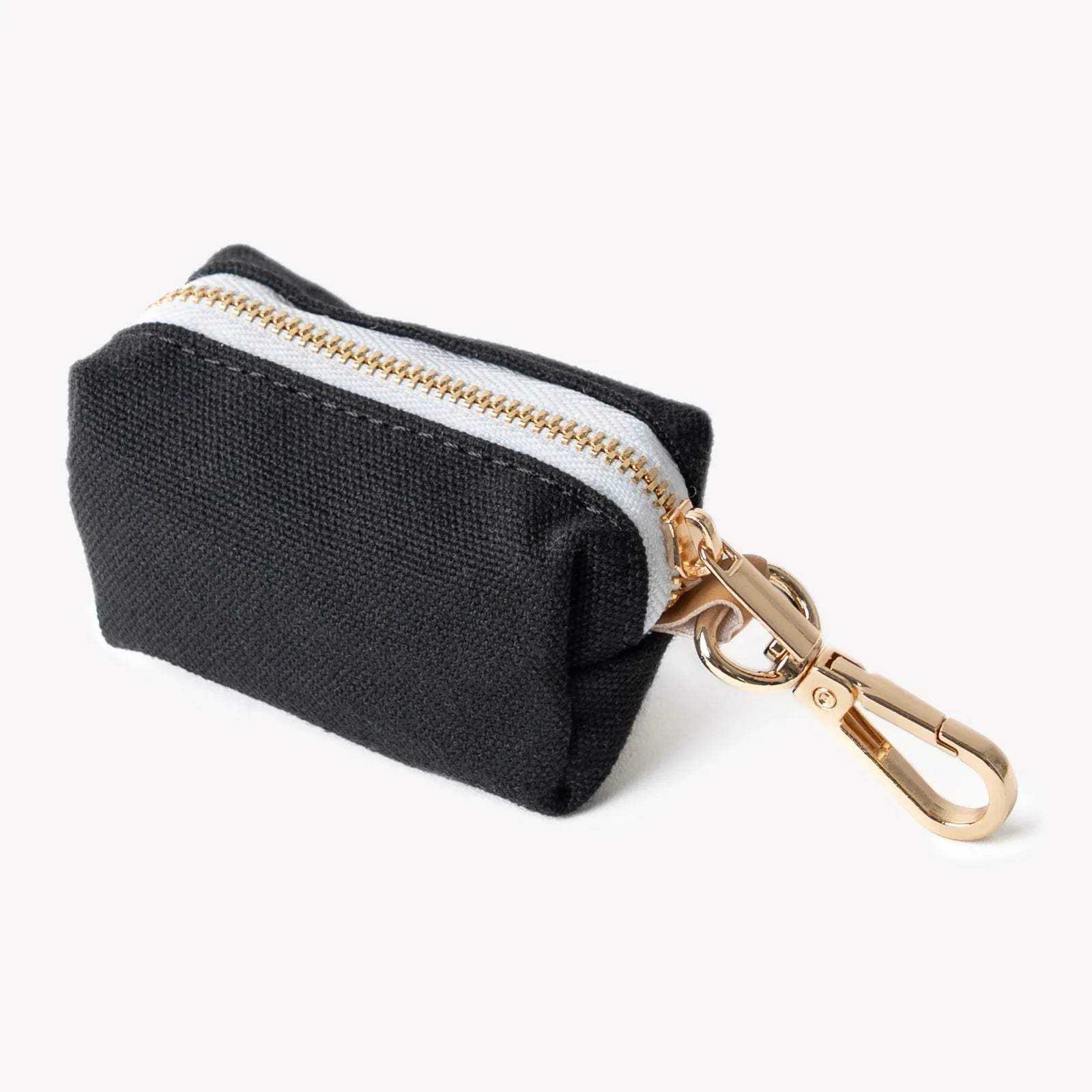 Black poop bag holder with gold zipper details, designed to clip onto leashes for stylish dog walks.
