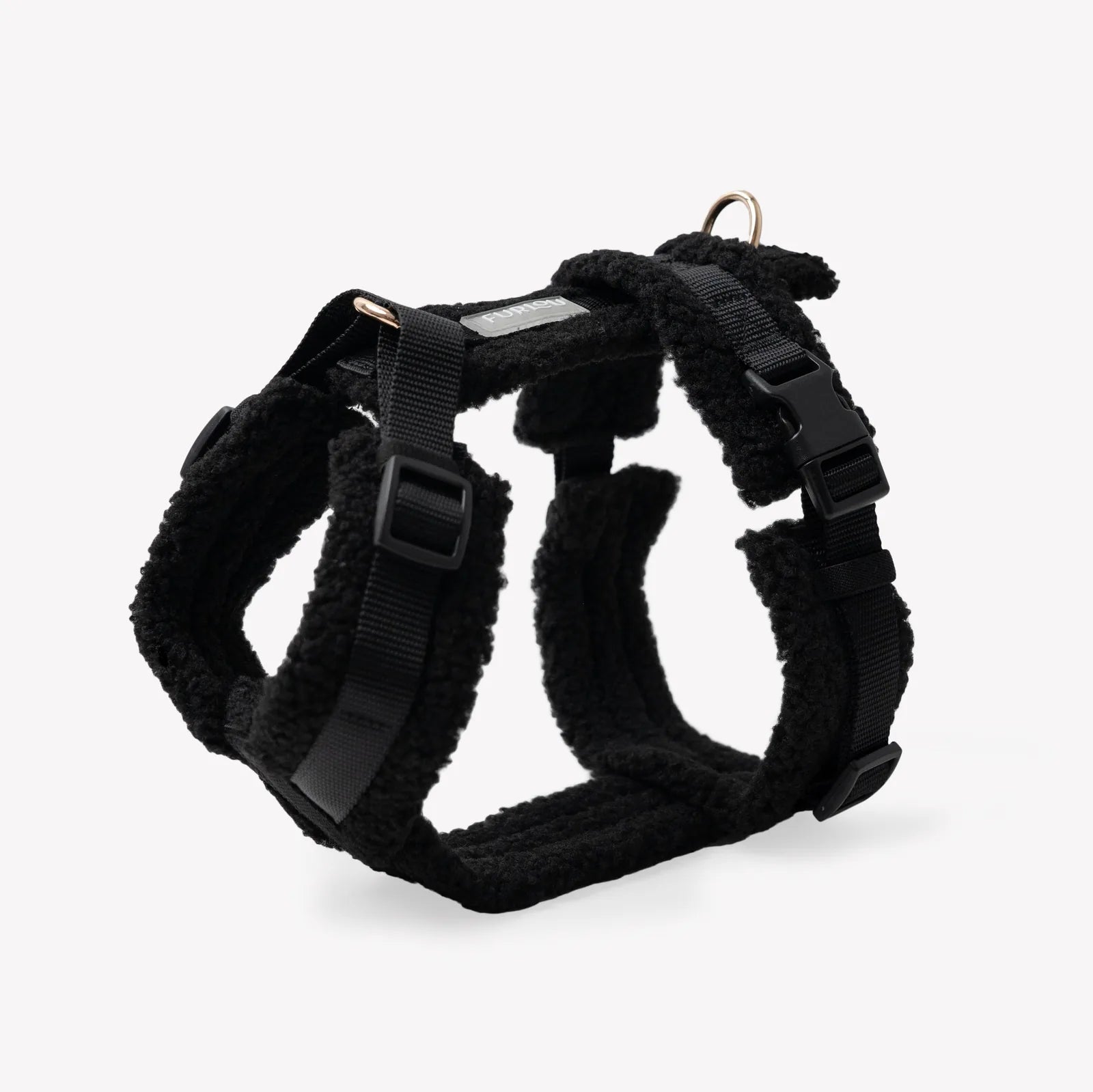 Black sherpa dog harness by FURLOU with adjustable straps and fluffy lining for comfort during walks.