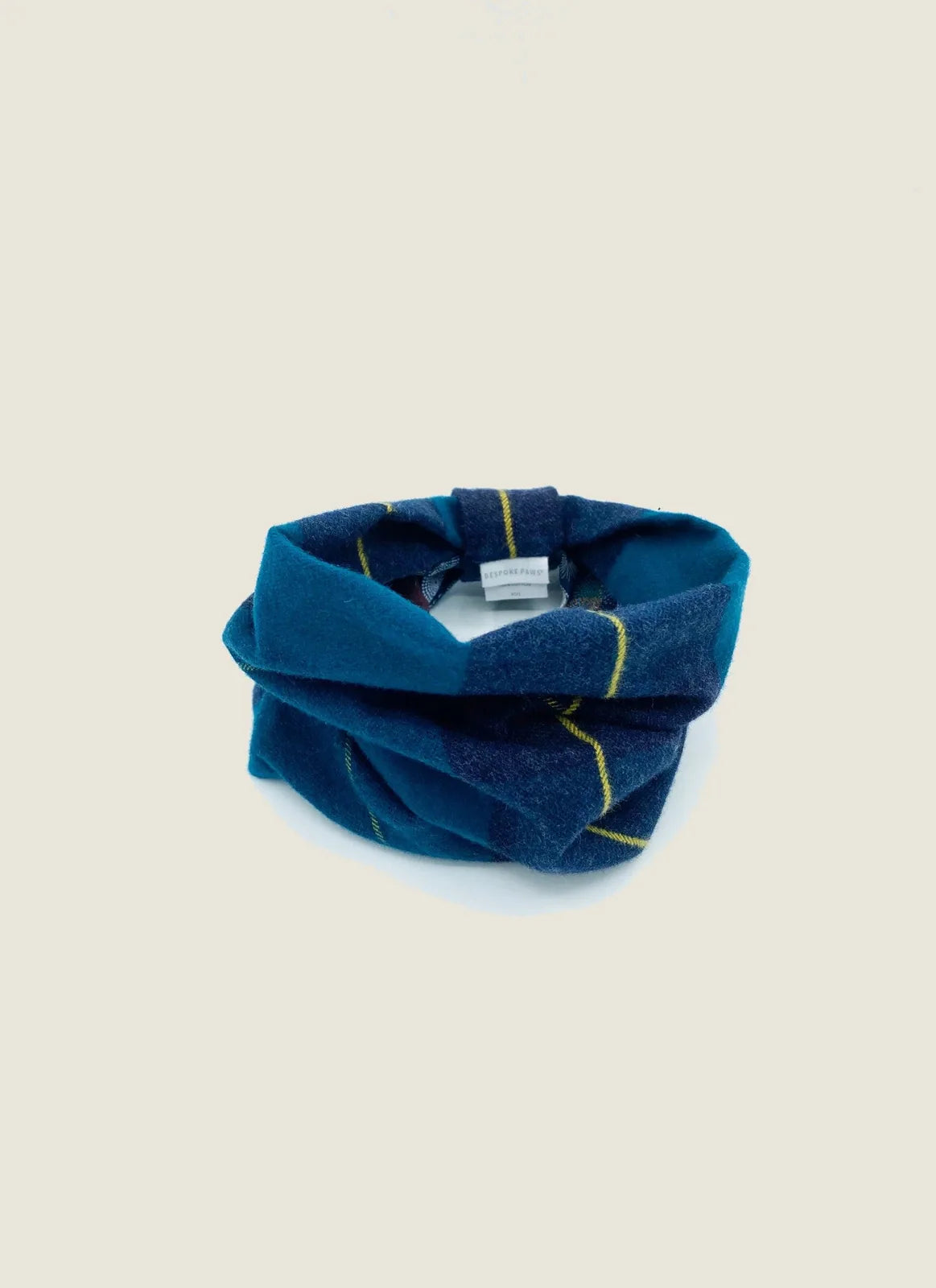 Reversible dog snood in teal with blue plaid design and yellow stripes, made from soft brushed cotton flannel.