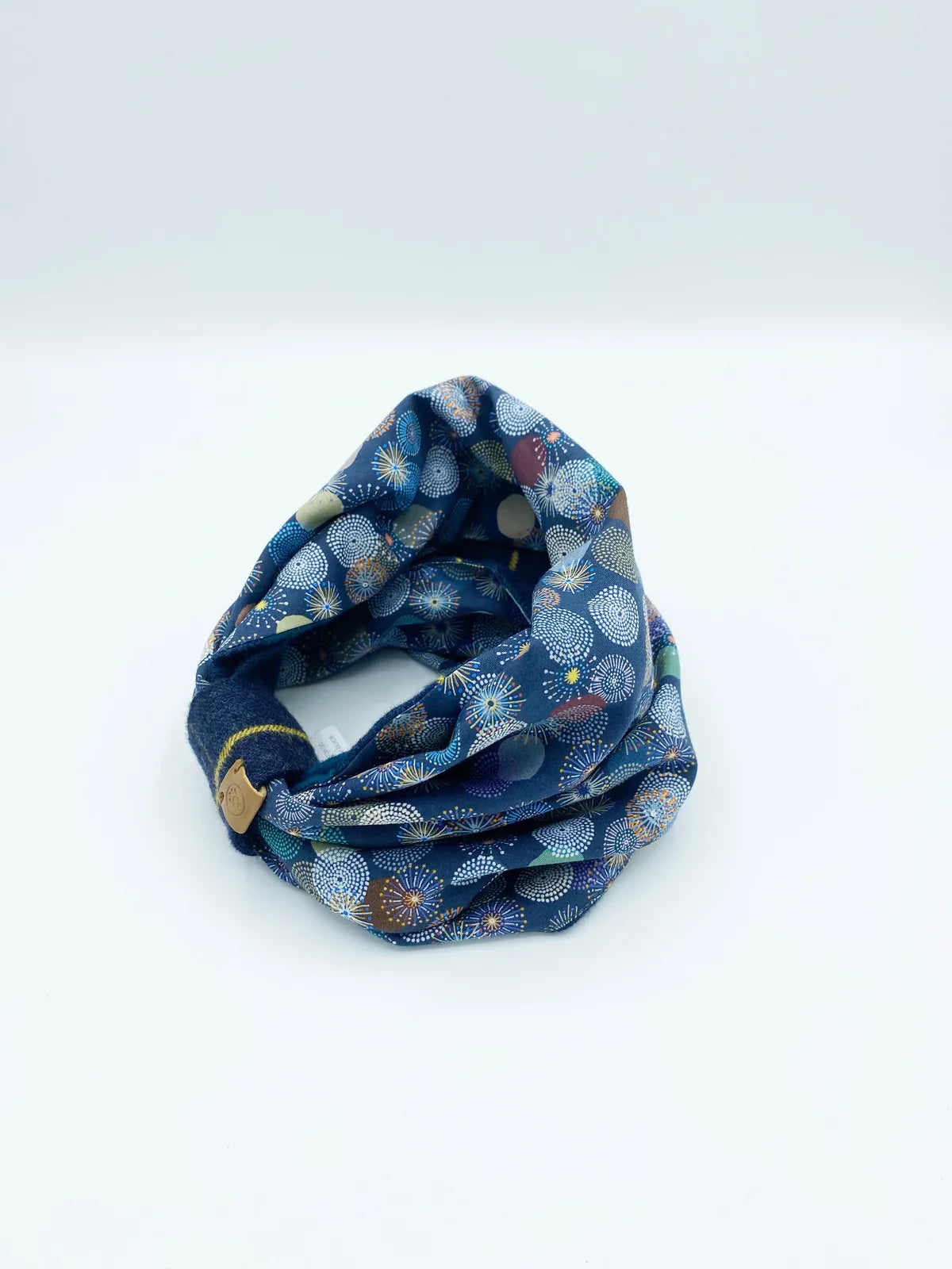 Reversible dog snood in blue with varying colorful patterns, crafted from soft cotton flannel for warmth and comfort.