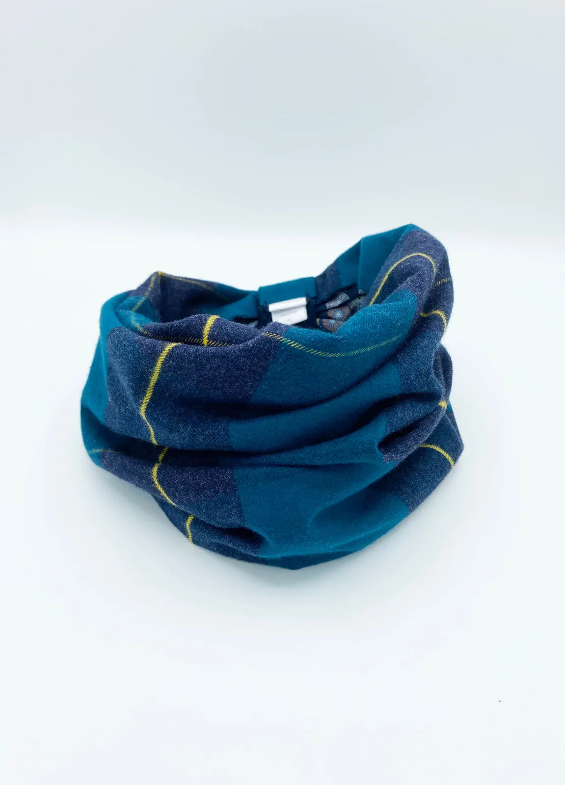 Reversible pet snood in teal with navy plaid and yellow accents, made of soft, brushed cotton flannel.