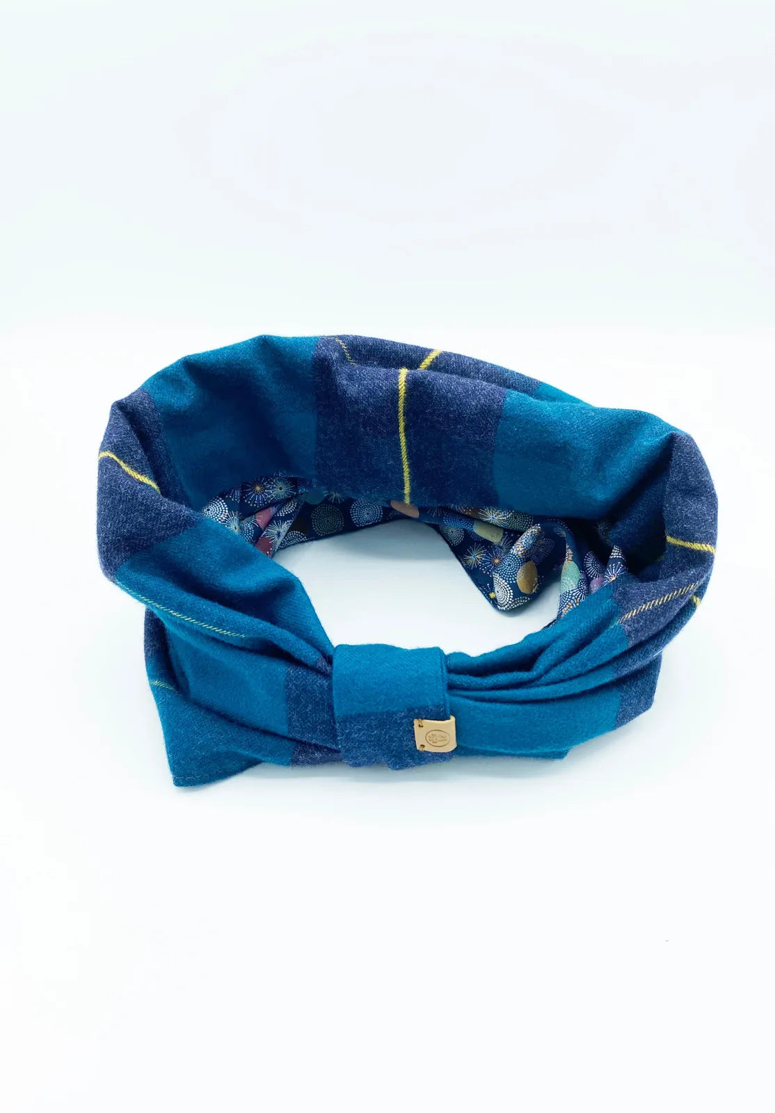 Reversible dog snood in teal and navy plaid, featuring a cozy brushed cotton design with a playful inner print.