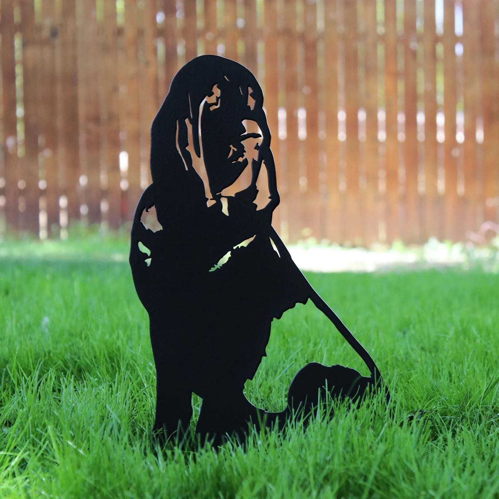 Black metal silhouette of a Bloodhound on green grass, designed for outdoor decor by My Metal Rescue.