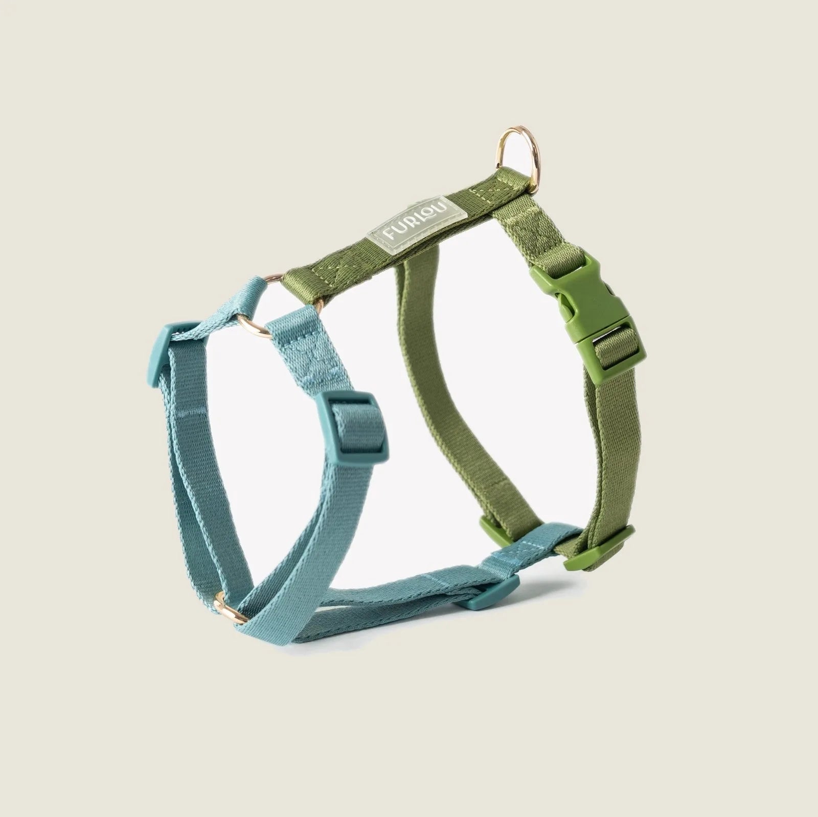 Blue and green strap harness by FURLOU, featuring adjustable points and gold hardware for a stylish and secure fit.