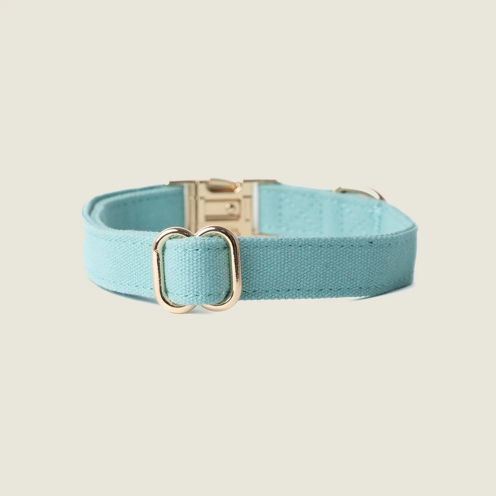 Light blue canvas dog collar by FURLOU featuring gold hardware, combining style with everyday comfort.
