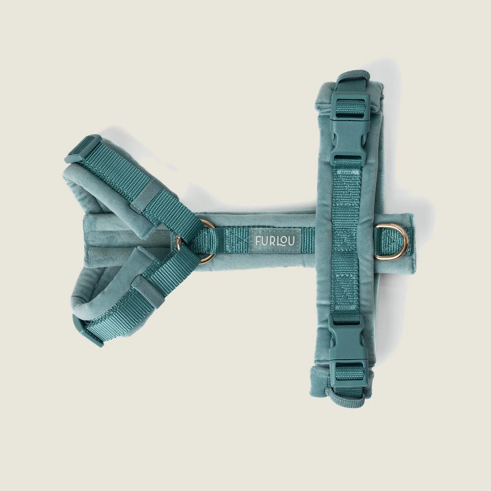 Soft blue velvet dog harness by FURLOU featuring adjustable straps and gold hardware for a stylish look.