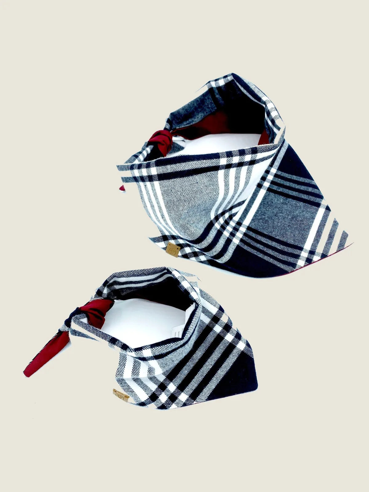Reversible navy and plaid pet bandana with a burgundy tie, made from soft cotton flannel and poplin.