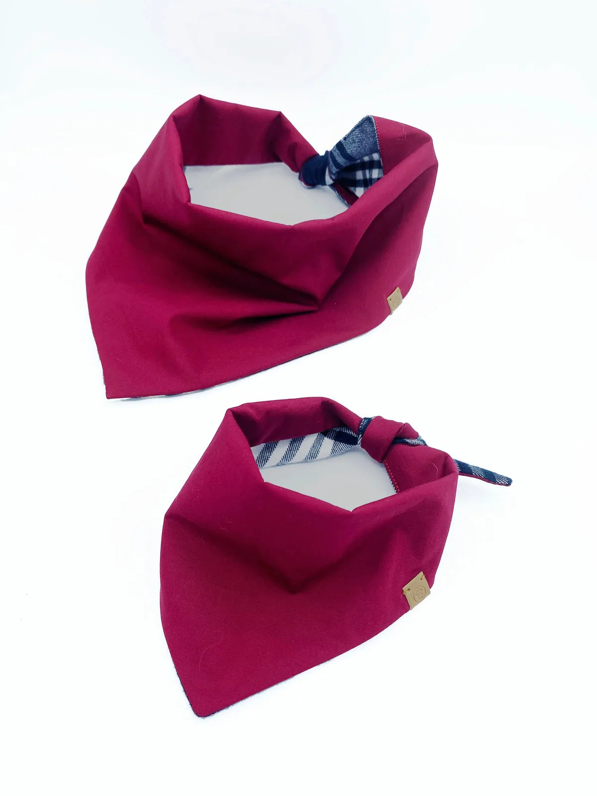 Reversible pet bandanas in burgundy with a plaid pattern, crafted from soft cotton flannel and poplin.