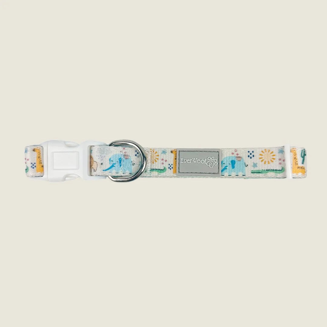 Adjustable dog collar featuring a colorful animal and sun pattern on soft polyester webbing with a white buckle.