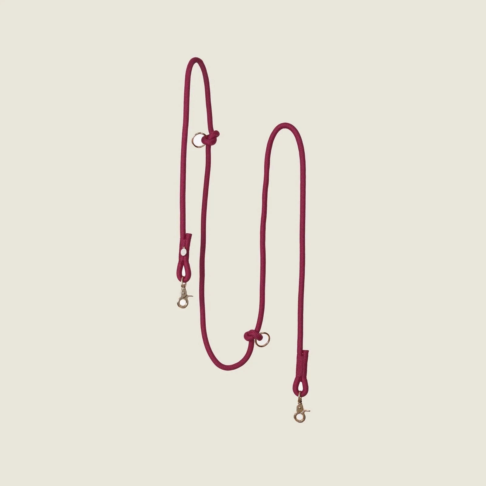 Bordeaux hands-free braided leash by FURLOU in deep red with gold clips, designed for practical dog walking.