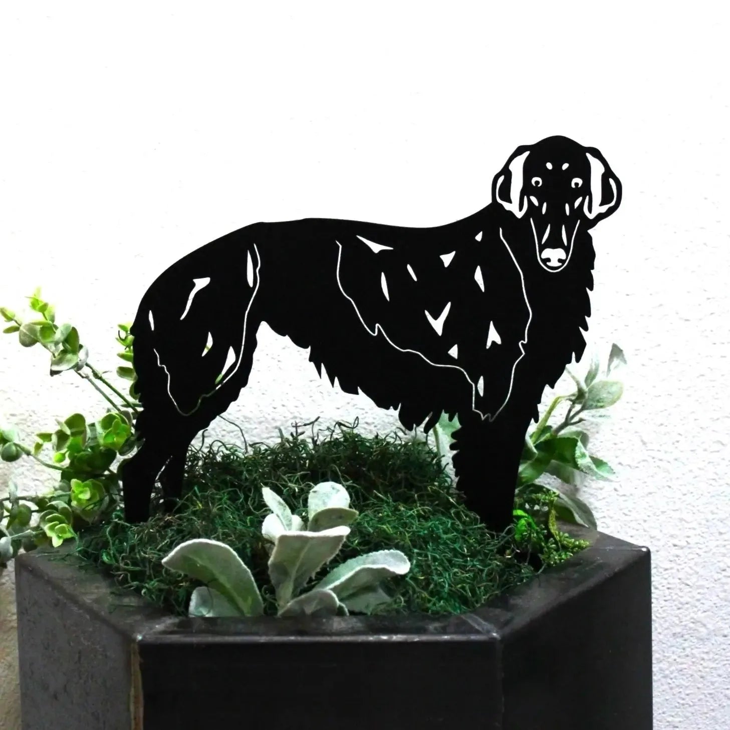 Black Borzoi dog silhouette in 11 gauge metal, displayed among greenery in a planter for unique outdoor decor.