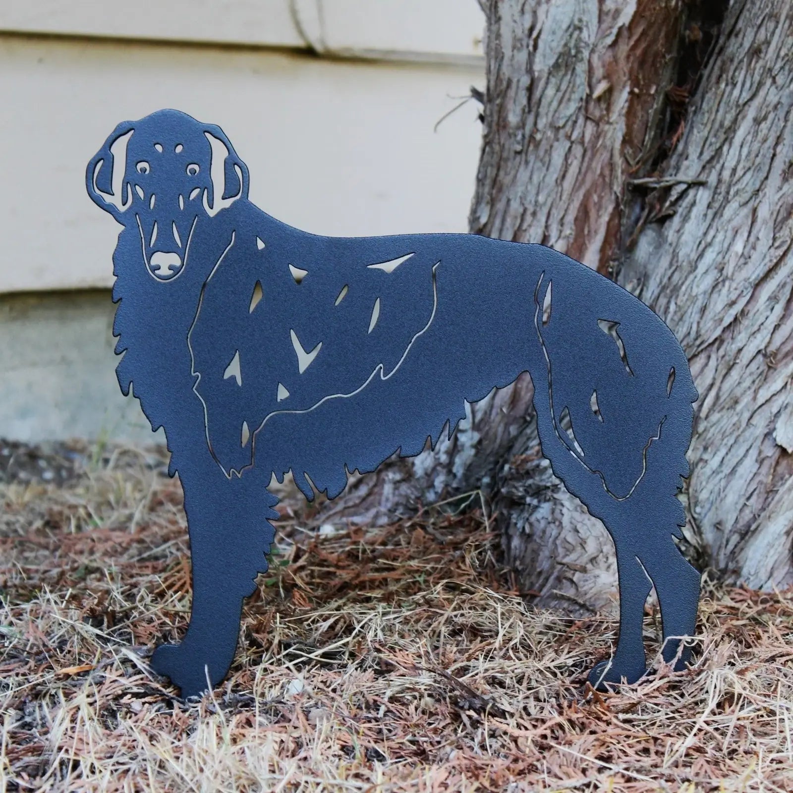 Borzoi metal silhouette in matte black, depicting a standing dog, surrounded by natural outdoor elements.