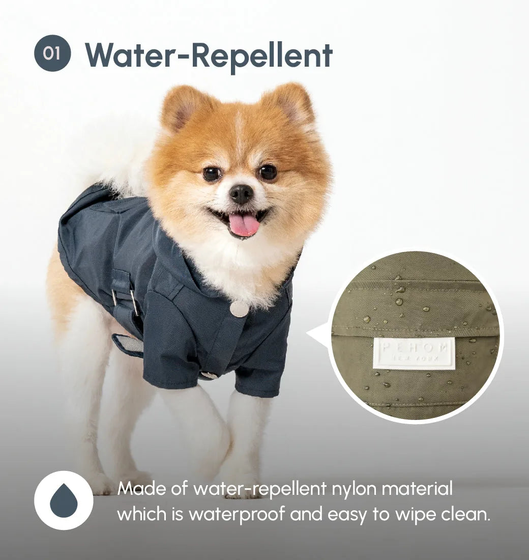 Blue water-repellent raincoat for dogs with logo snap closures and adjustable velcro for comfort and fit.