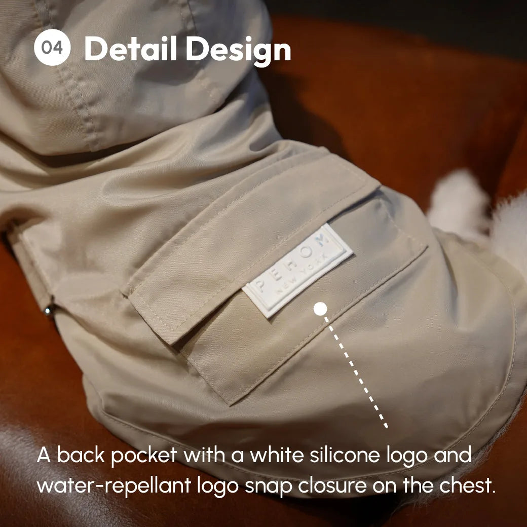 Back pocket with a white silicone logo and water-repellent snap closure on the chest of the gray Bowery Raincoat.