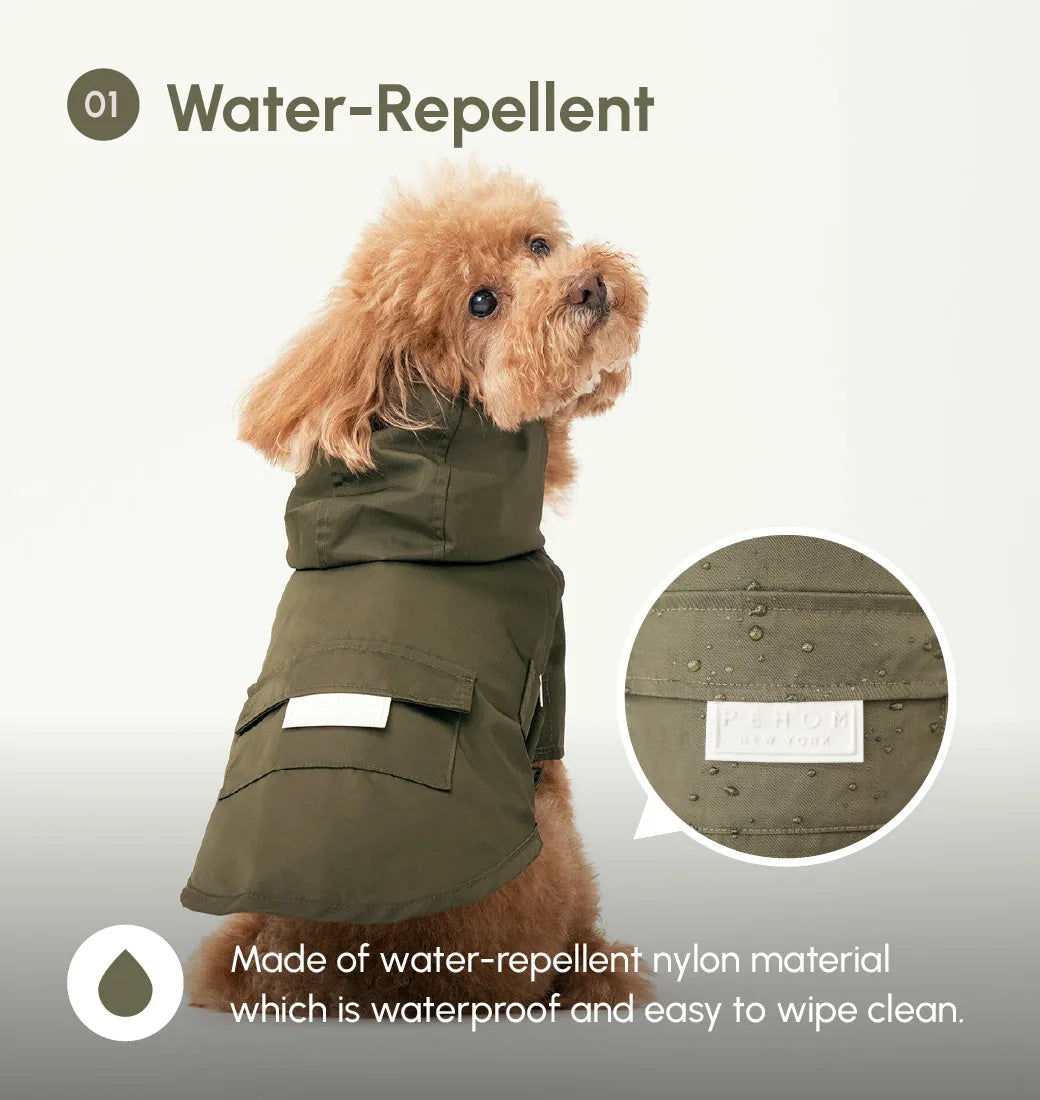 Water-repellent green dog raincoat with adjustable hood, featuring logo snaps and pockets. Perfect for wet weather.