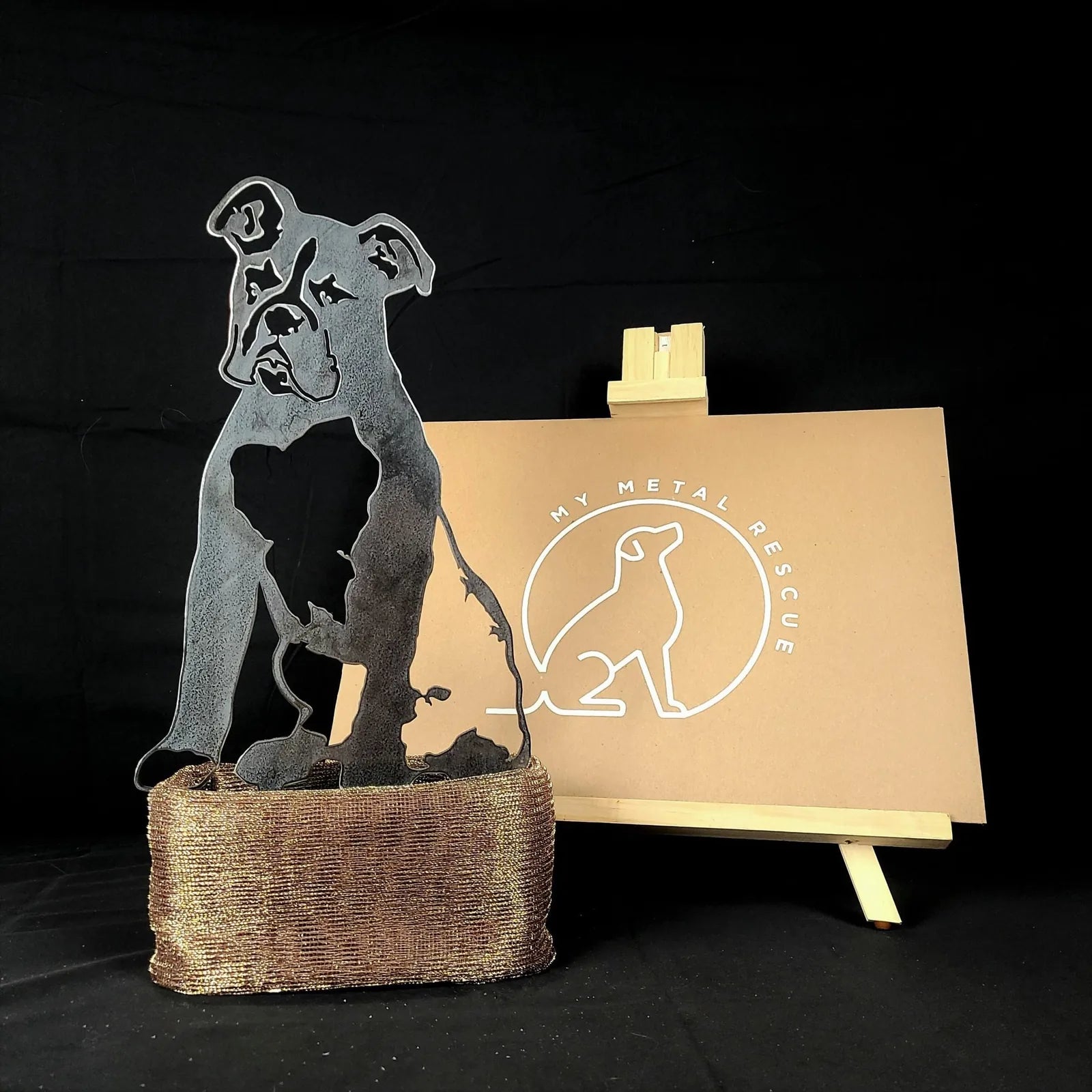 Boxer metal silhouette in Corten steel with rustic finish, displayed with branded sign on a wooden easel.
