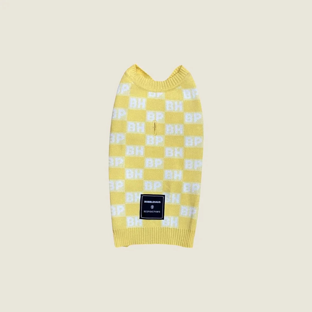 Yellow dog sweater vest with a check pattern featuring BP and BH logos, made from soft recycled cotton knit.