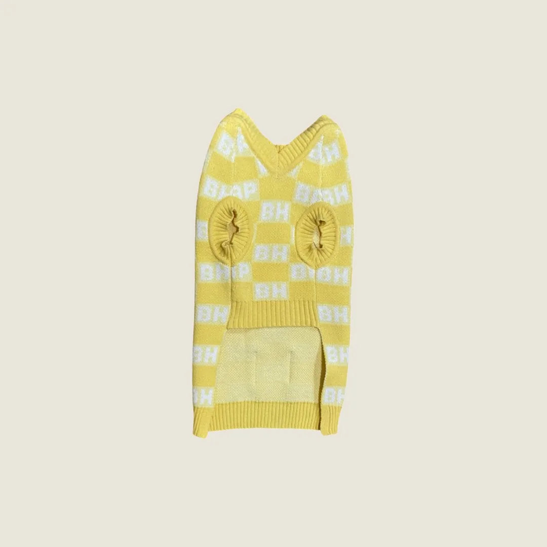 Yellow checkered dog sweater vest with jacquard pattern, featuring holes for legs and a cozy knit design.