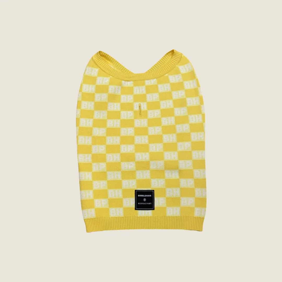 Yellow check sweater vest for dogs, featuring a BP x BH pattern and soft recycled knit material.