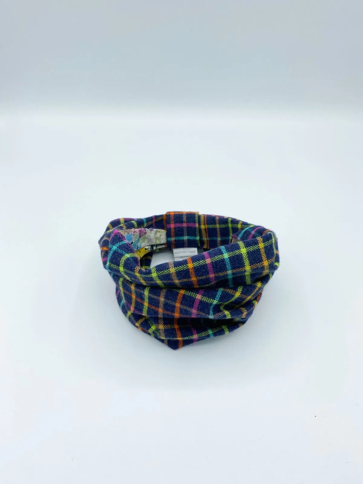 Reversible pet snood in black and colored plaid, crafted from soft cotton flannel for cozy winter walks.