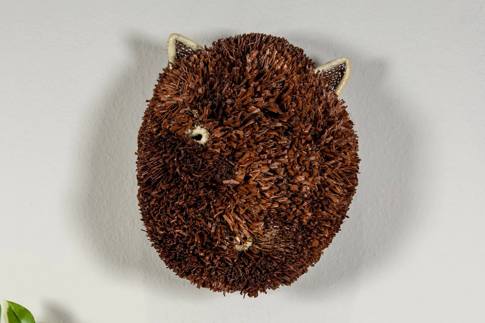 Handwoven brown and white Labradoodle dog mask, crafted from natural reeds, with distinctive textured fur and ears.