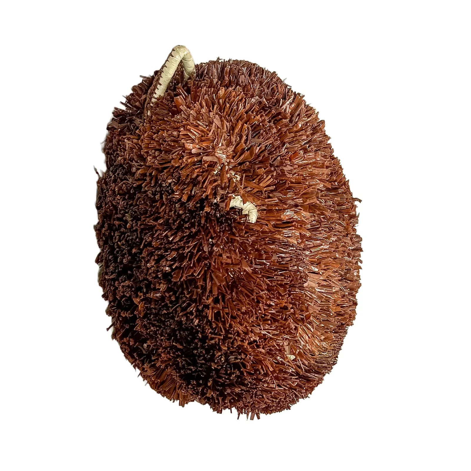 Handwoven brown and white Labradoodle mask made of local reeds, featuring a textured, natural design.